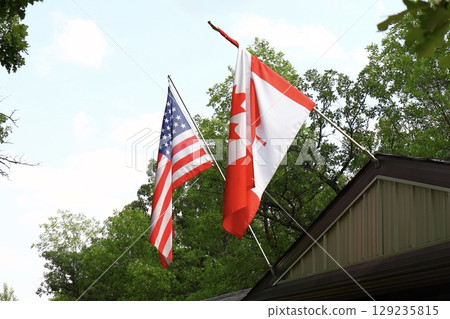 American and Canadian Flags on Building 129235815