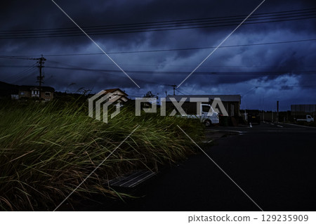 <Material> A view of a fishing port and a light car at dawn in summer 129235909