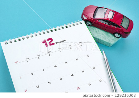 Automotive work desktop with calculator and cell phone Automotive work desktop with calculator and cell phone 129236308