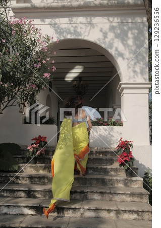 Graceful Indian Woman Draped in Traditional Saree Graceful Indian Woman Draped in Traditional Saree 129236556