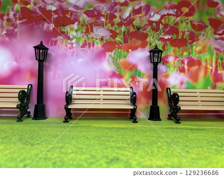 A miniature bench in a blooming park 129236686
