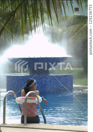 Female in Swimming pool at resort 129236755
