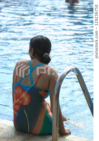 Female in Swimming pool at resort 129236758