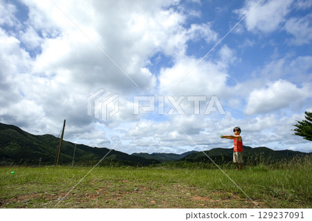<Material> Boy playing catch in the park 129237091
