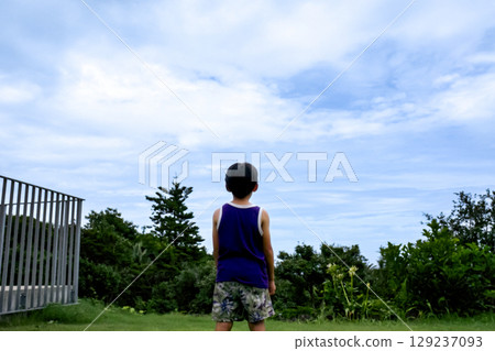 <素材> 夏日公園裡仰望天空的男孩 129237093
