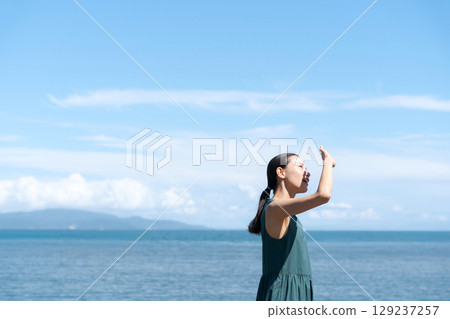 A woman refreshing herself in the sea 129237257