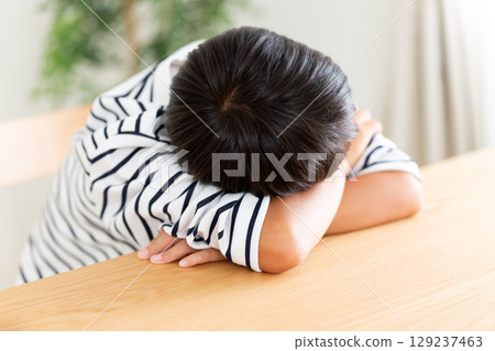 A sulky elementary school boy 129237463