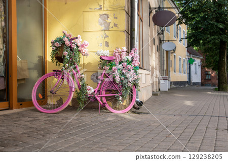 Vintage Pink Bicycle Decorated with Summer Flowers Outdoors Vintage Pink Bicycle Decorated with Summer Flowers Outdoors 129238205