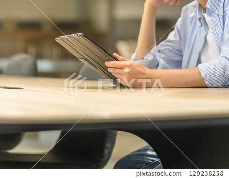 Hands of a male student using a tablet Hands of a male student using a tablet 129238258