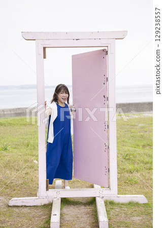 A woman who opens a door A woman who opens a door 129238557