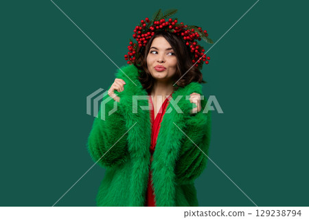 Woman in green coat and red berry wreath Woman in green coat and red berry wreath 129238794