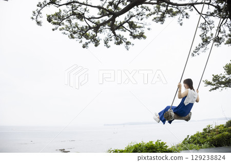 Woman playing on a swing 129238824