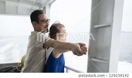 A couple looking out to the sea 129239142