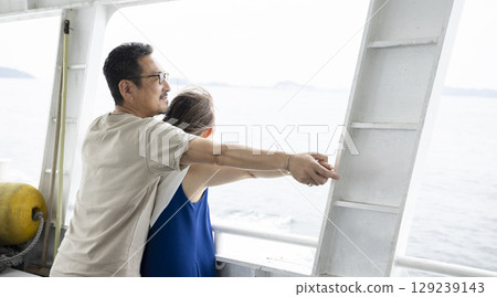 A couple looking out to the sea 129239143