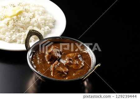 Chicken masala curry and butter rice 129239444