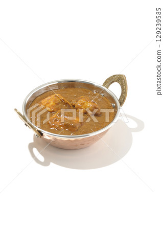 Chicken masala curry photographed on a white background Chicken masala curry photographed on a white background 129239585