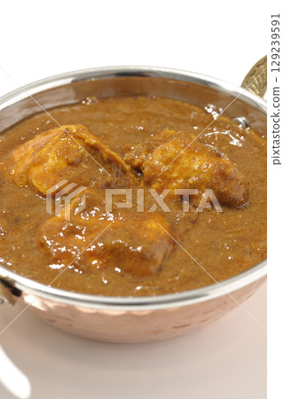 Chicken masala curry photographed on a white background 129239591