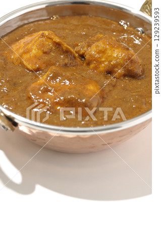Chicken masala curry photographed on a white background 129239593