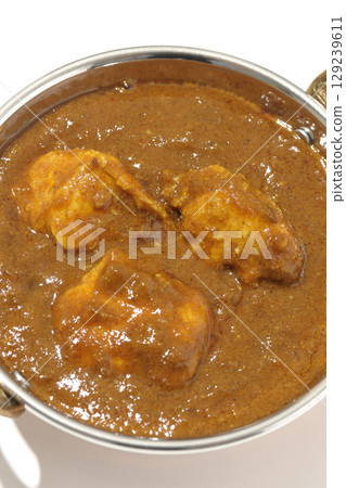 Chicken masala curry photographed on a white background 129239611