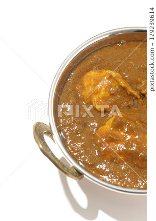 Chicken masala curry photographed on a white background Chicken masala curry photographed on a white background 129239614
