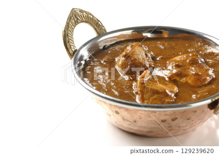 Chicken masala curry photographed on a white background Chicken masala curry photographed on a white background 129239620