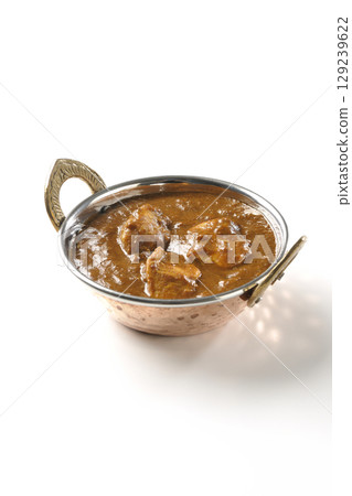Chicken masala curry photographed on a white background Chicken masala curry photographed on a white background 129239622