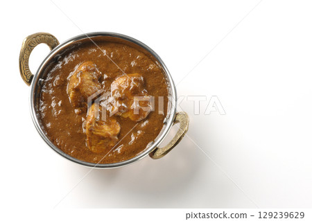 Chicken masala curry photographed on a white background Chicken masala curry photographed on a white background 129239629