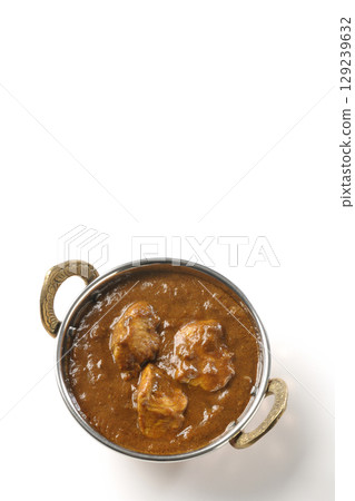 Chicken masala curry photographed on a white background 129239632