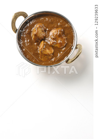 Chicken masala curry photographed on a white background Chicken masala curry photographed on a white background 129239633