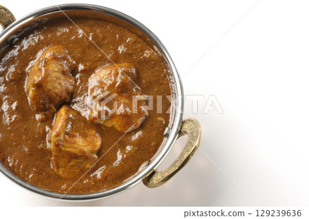 Chicken masala curry photographed on a white background 129239636