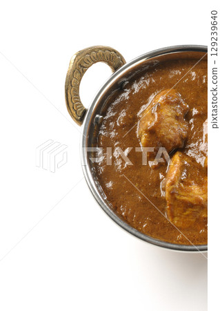 Chicken masala curry photographed on a white background Chicken masala curry photographed on a white background 129239640