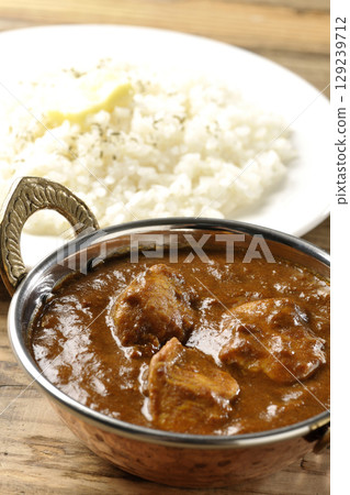 Chicken masala curry and butter rice 129239712
