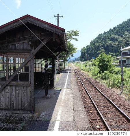 The wooden station building of Abe Station on the Wakasa Railway and the mountain range 129239774