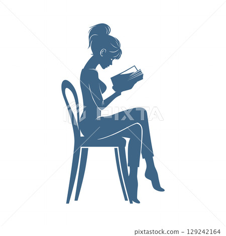 Still Moment of Teen Girl Reading Book on Chair 129242164