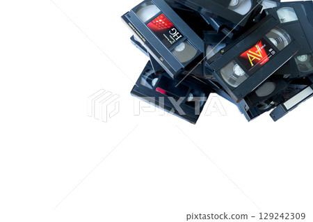 A pile of VHS video tapes on a white background 129242309