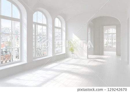 Spacious room with big windows and light decor. Sun rays shine through with floral vase on floor. Ideal for contemporary home design projects. 129242670