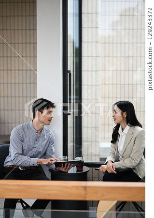 Friendly conversation between colleagues during a coffee break Friendly conversation between colleagues during a coffee break 129243372