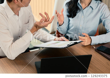 Business colleagues collaborating on a project during a meeting in modern office 129243375