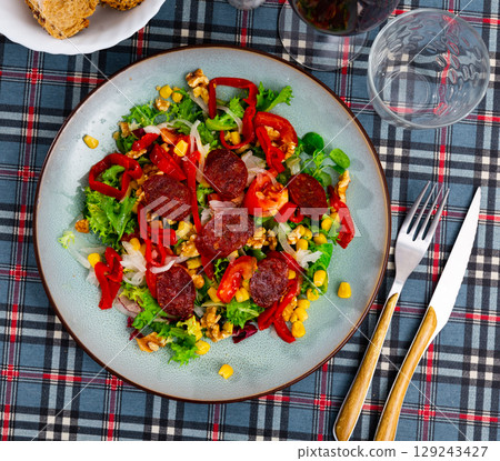Vitamin salad of fresh vegetables, lettuce leaf, corn, bel pepper and chorizo. Vitamin salad of fresh vegetables, lettuce leaf, corn, bel pepper and chorizo. 129243427