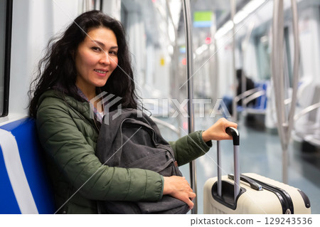 Young woman passenger sitting in subway car Young woman passenger sitting in subway car 129243536