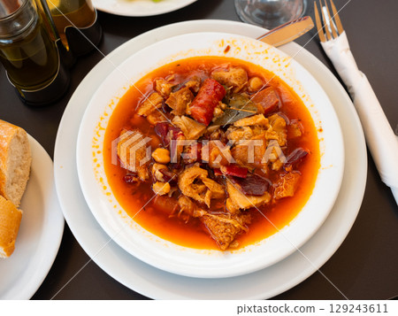 Portion of stewed tripe with chickpea is cooked in plate - stomach of cattle Portion of stewed tripe with chickpea is cooked in plate - stomach of cattle 129243611