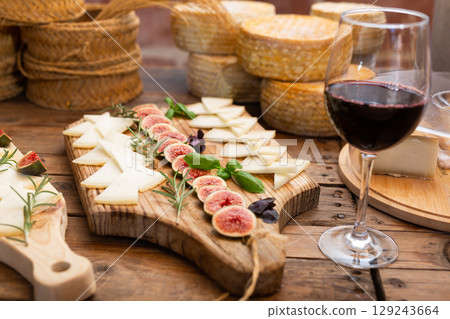 Cheese plate - cheeses and figs on wooden background 129243664