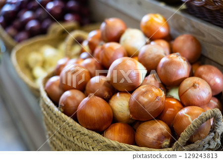 Close-up view of onions in straw basket 129243813