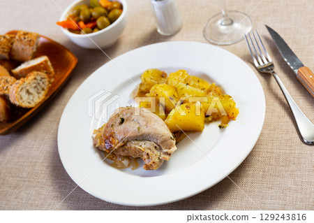 Stewed pork and potato pieces served in a plate 129243816