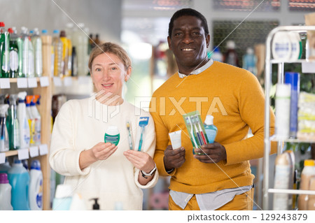 Couple man and woman choosing dental care products 129243879