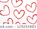 Handmade Valentine's Day card with red printed heart stamps on white background. 129243883