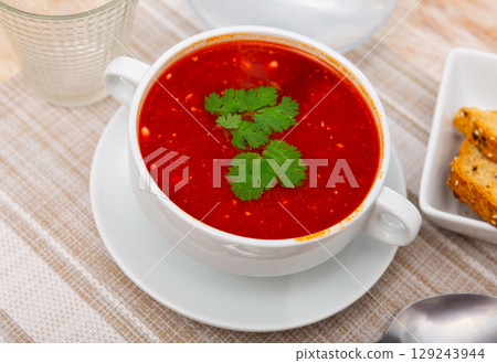 Beet soup with veal meat garnished with fresh parsley Beet soup with veal meat garnished with fresh parsley 129243944