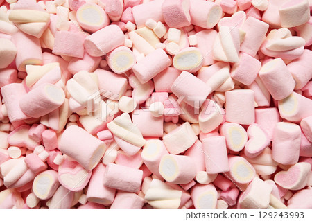 Confectionery and sweeties varieties background: light pink and white marshmallows, sugar confetti and candies, selective focus Confectionery and sweeties varieties background: light pink and white marshmallows, sugar confetti and candies, selective focus 129243993