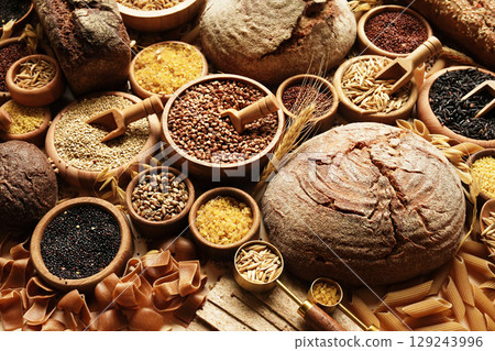 Whole grains concept background. Colorful mix of grain varieties: oat and wheat, rice and millet, buckwheat and barley, quinoa and polenta. Food ingridients for healthy diet. Selective focus 129243996