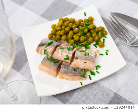 Appetizing herring with peas 129244014